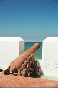 Built structure on beach against clear blue sky