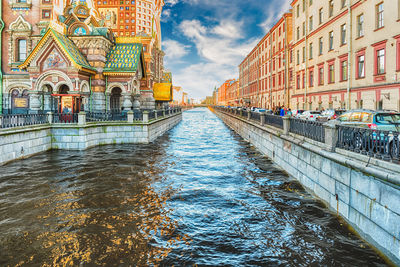 Bridge over canal amidst buildings in city