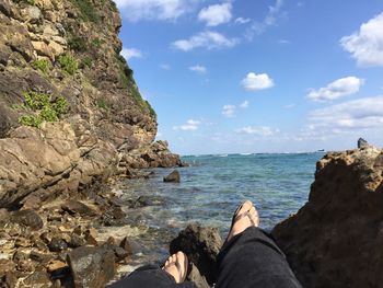 Low section of woman relaxing on beach