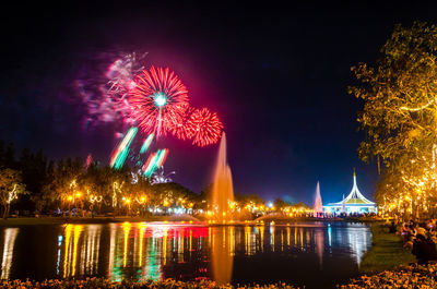 Firework display over river at night