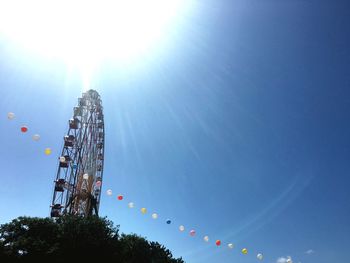 Low angle view of ferris wheel against sky