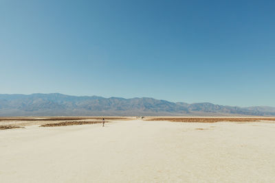 Scenic view of desert against clear blue sky