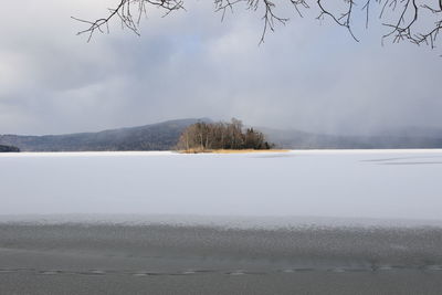 Scenic view of lake against sky during winter