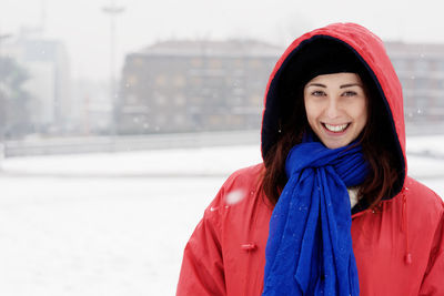 Portrait of woman standing on snow against sky