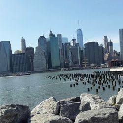 View of sea and cityscape against clear sky