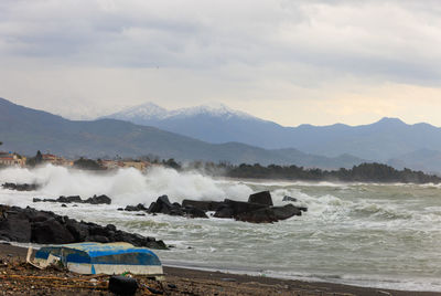 Scenic view of sea and mountains against sky