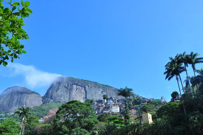 Low angle view of buildings against clear blue sky