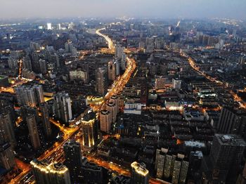 High angle view of illuminated city buildings against sky