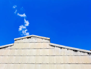 Low angle view of building against blue sky