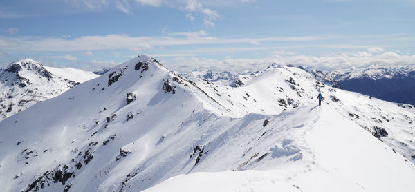 Scenic view of snow covered mountains against sky