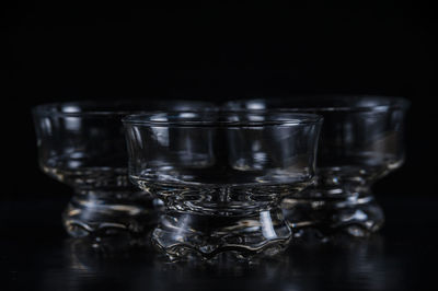 Close-up of glass bowls against black background