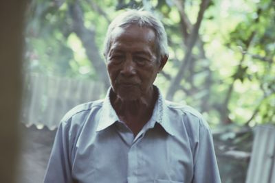Portrait of man standing in forest
