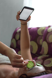 Midsection of woman holding mobile phone