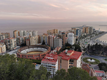 High angle view of buildings against sky during sunset