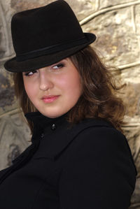 Portrait of young woman wearing hat