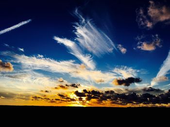 Silhouette landscape against scenic sky