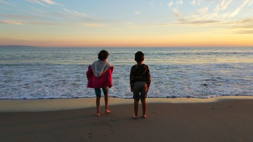 People on beach at sunset