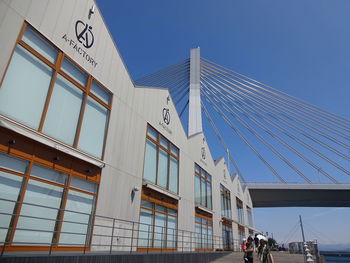 Low angle view of modern building against clear blue sky