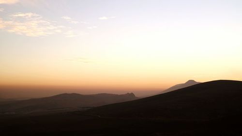 Scenic view of mountains against sky during sunset