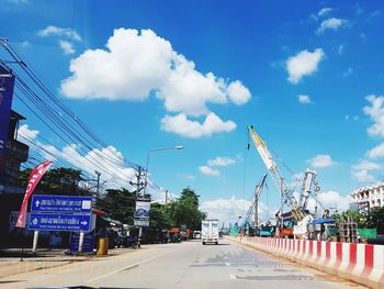 Road by street against sky