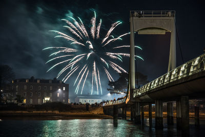 Low angle view of firework display at night