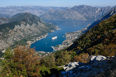 High angle view of lake and mountains against sky