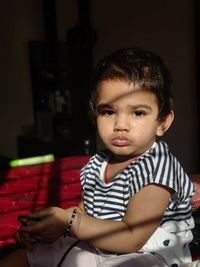 Portrait of boy looking away while sitting at home