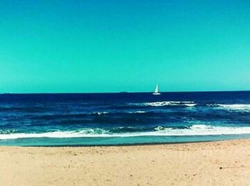 Scenic view of sea against blue sky