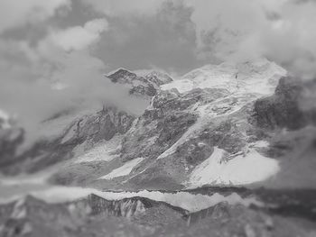 Scenic view of mountains against cloudy sky