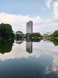 Reflection of building in city against sky