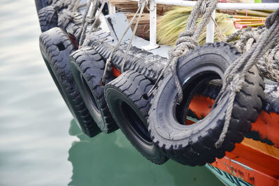 Close-up of rope tied to boat moored in lake