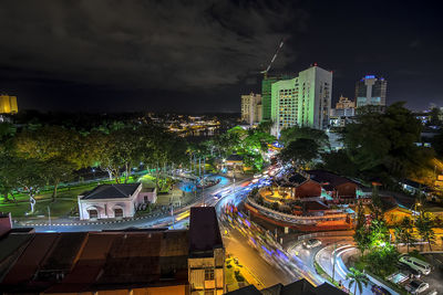 High angle view of illuminated cityscape against sky at night