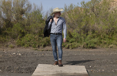 Adult man in cowboy hat in oasis of desert. almeria, spain