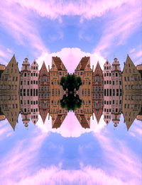 Reflection of buildings in river against sky