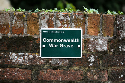 Close-up of information sign on wall