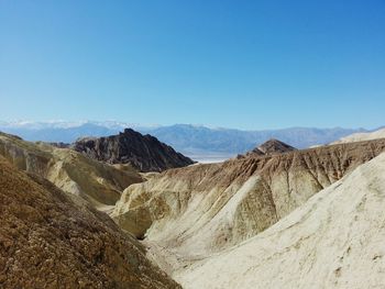 Scenic view of mountains against clear blue sky