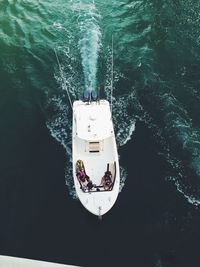 High angle view of people sitting in motorboat at sea