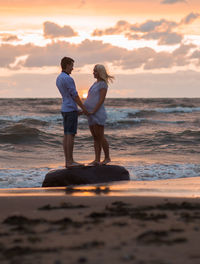 Rear view of friends on beach