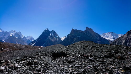 Scenic view of snowcapped mountains against clear blue sky