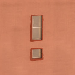 Windows on brown wall