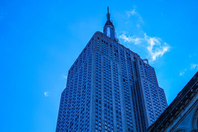 Low angle view of modern building against blue sky