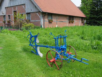 Bicycle parked outside house on field