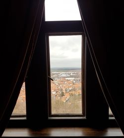 View of sea seen through window