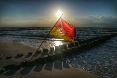 Scenic view of beach against sky during sunset