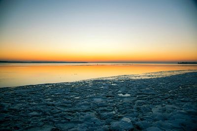 Scenic view of sea against clear sky during sunset