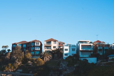 Houses against clear blue sky