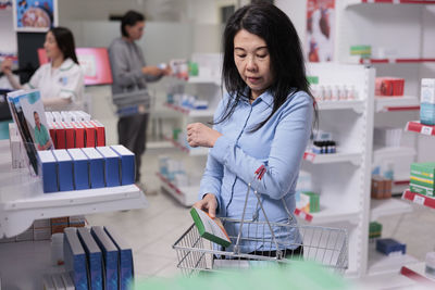 Portrait of young woman using mobile phone in laboratory