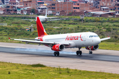 Airplane flying over airport runway