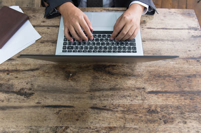 High angle view of man using laptop on table