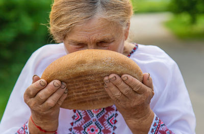 Close-up of woman holding coconut